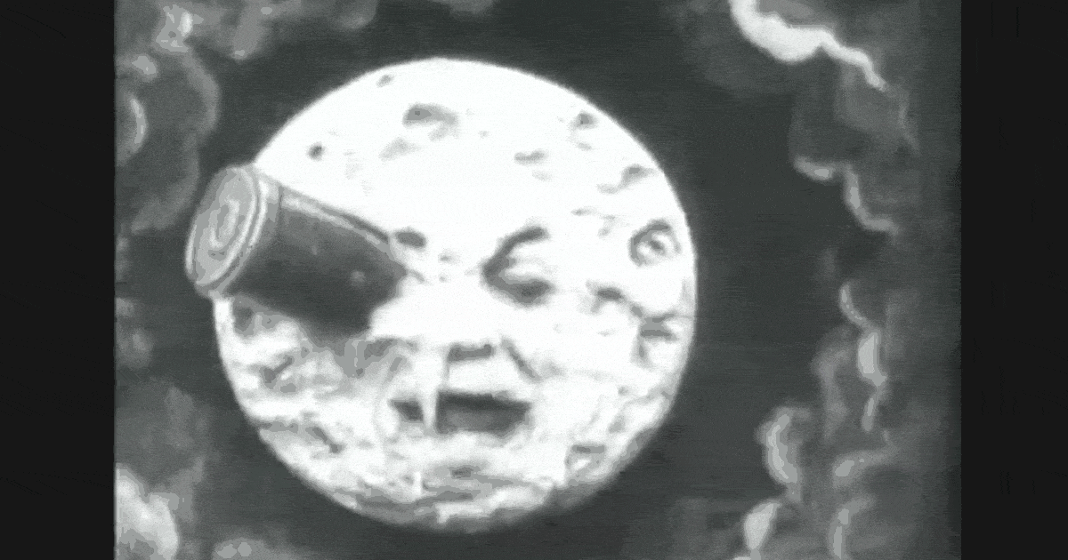 Black and white video clip of a face on the Moon with a rocket cylinder stuck in one eye.